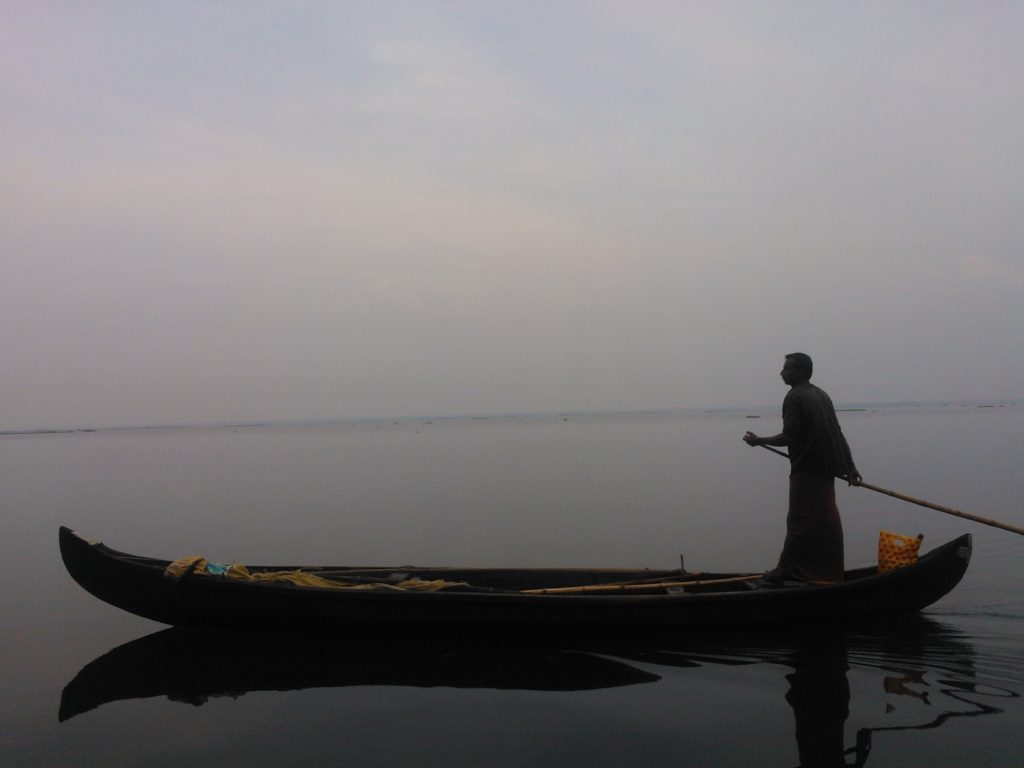 Fisherman & his boat on Vembanad Lake
